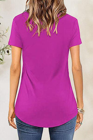 a woman wearing a purple shirt and jeans