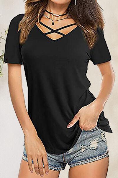 a woman wearing a black top and denim shorts
