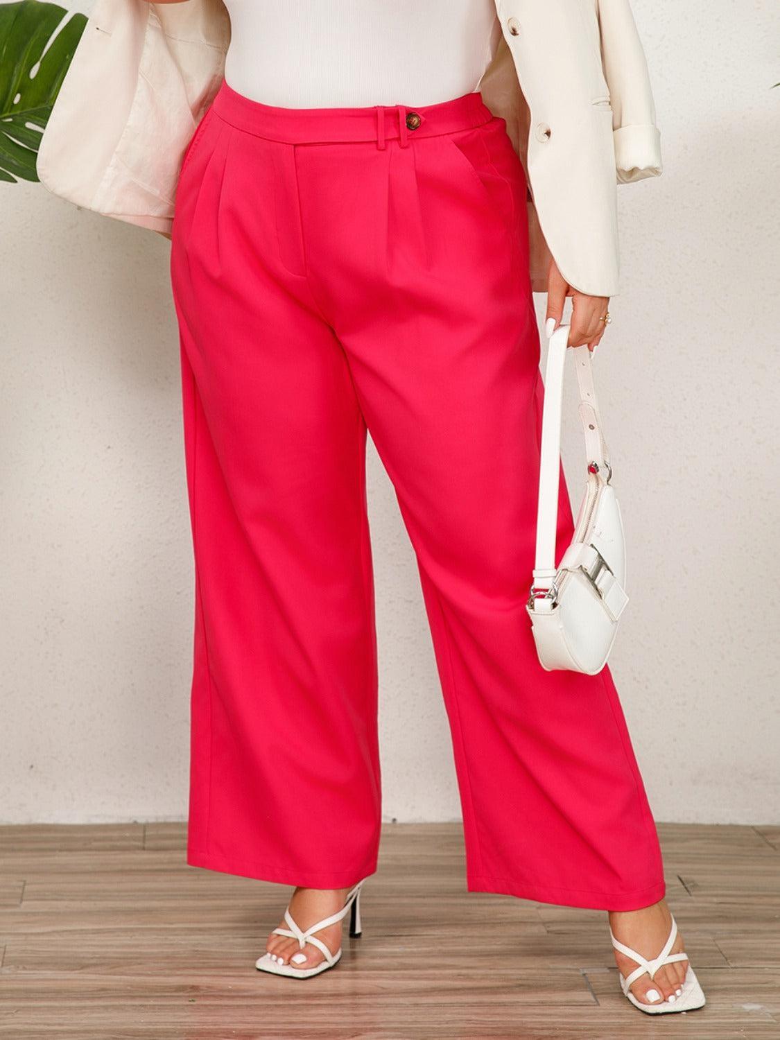 a woman in a white top and pink pants