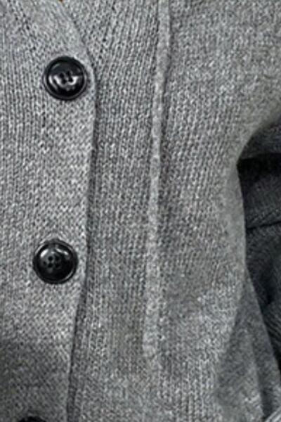 a close up of a person wearing a sweater and tie
