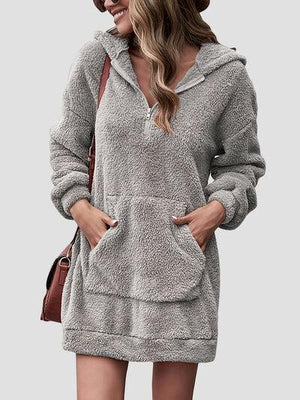 a woman wearing a gray hooded sweatshirt dress