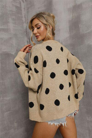 a woman wearing a polka dot sweater