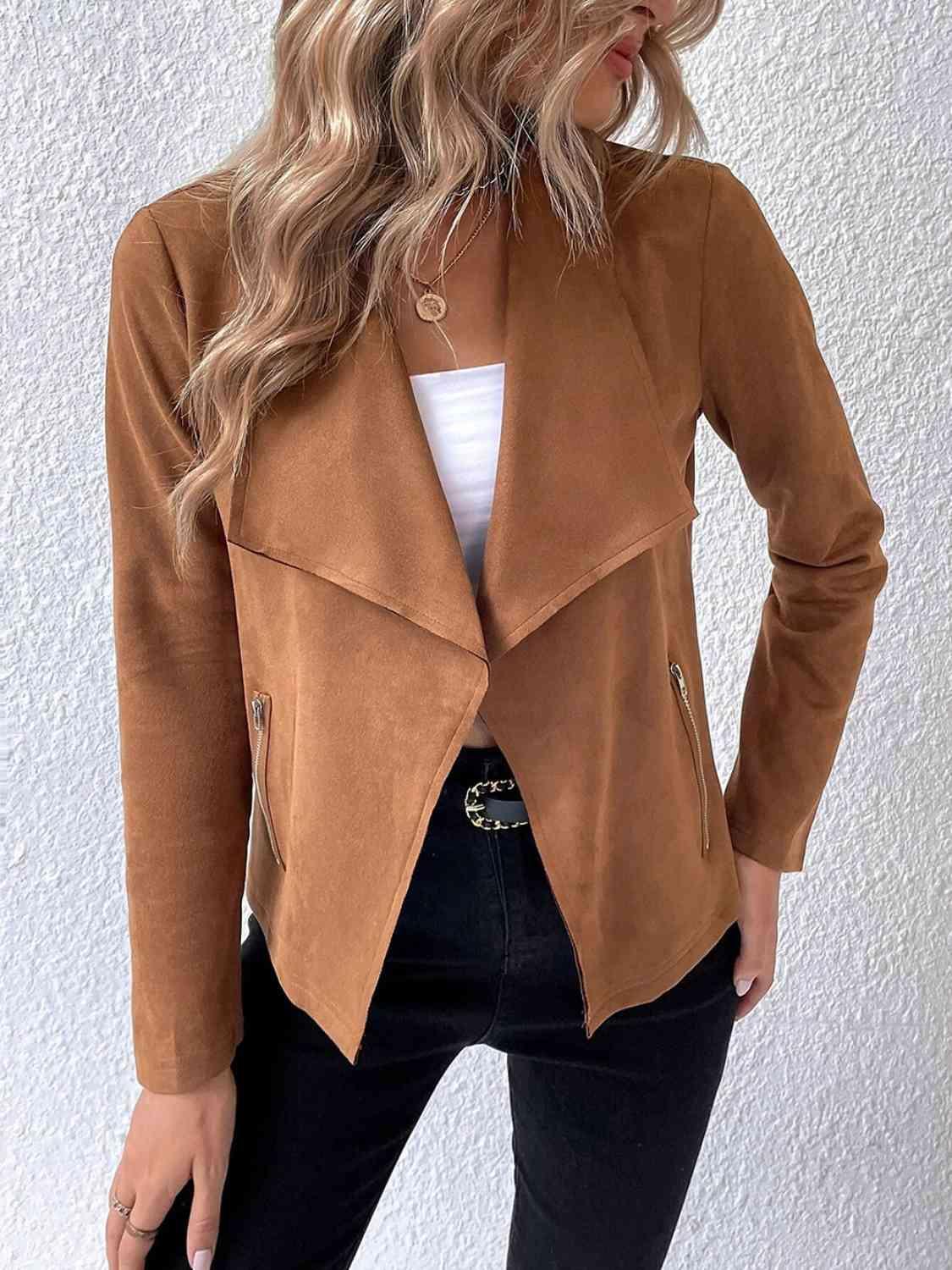 a woman wearing a brown jacket and black pants