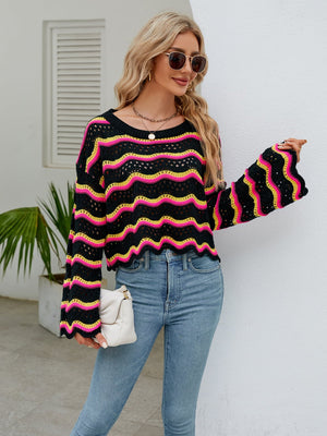 a woman wearing a colorful sweater and jeans