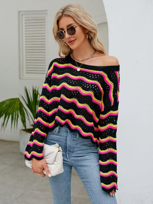 a woman wearing a black and pink striped sweater