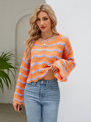 a woman wearing an orange and blue striped sweater