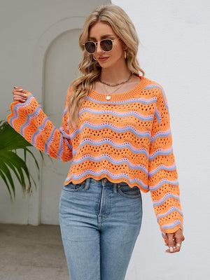 a woman wearing an orange sweater and jeans