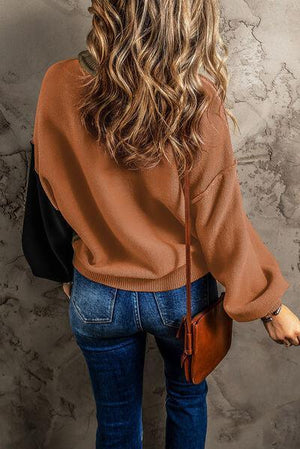 a woman with long hair wearing a brown sweater