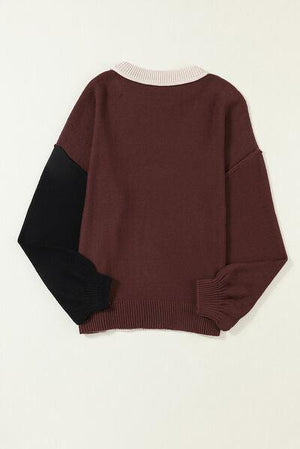 a brown sweater with black and white sleeves