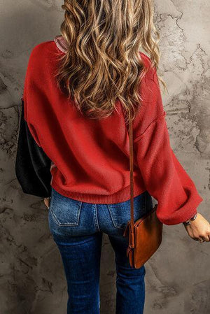 a woman with long hair wearing a red sweater
