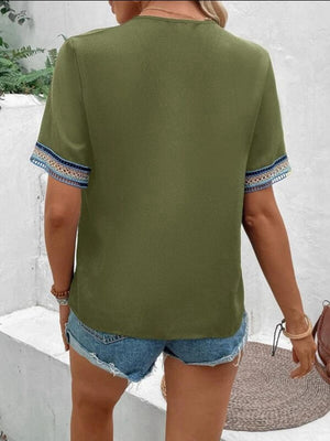 a woman wearing a green shirt and shorts
