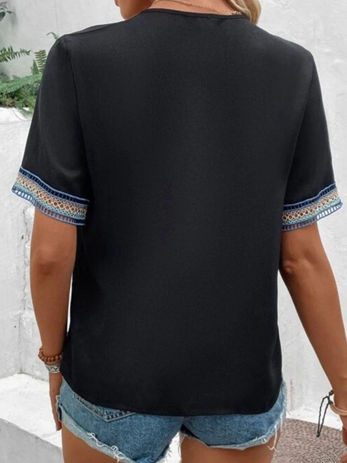 a woman wearing shorts and a black top