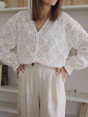 a woman standing in front of a book shelf
