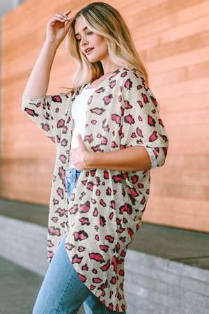 a woman wearing a leopard print top and jeans