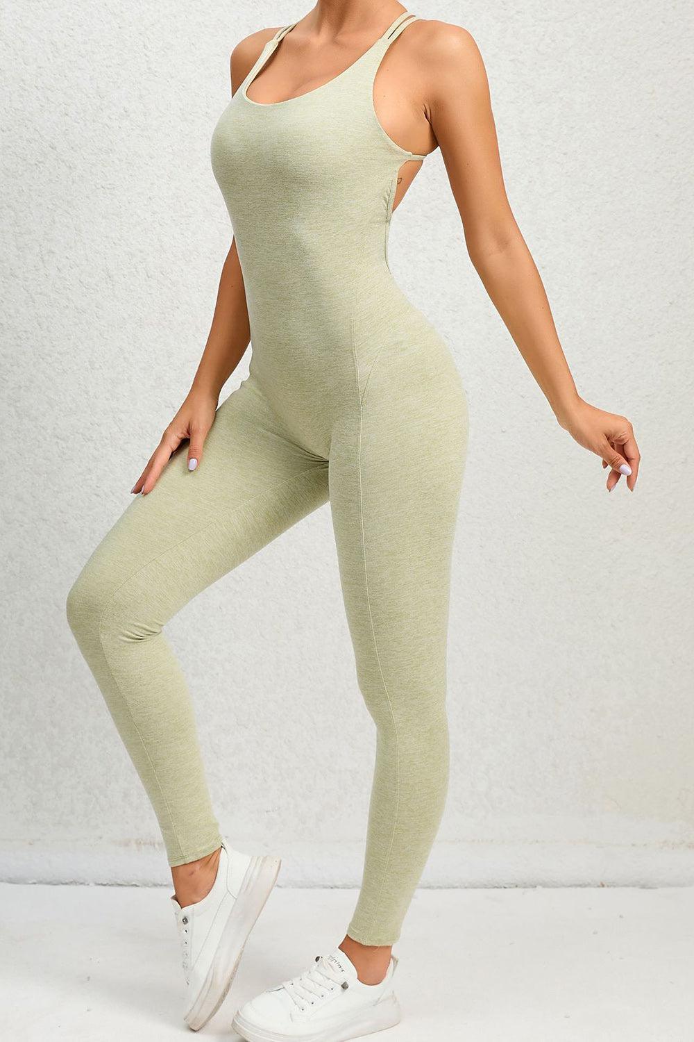 a woman in a light green bodysuit posing for a picture