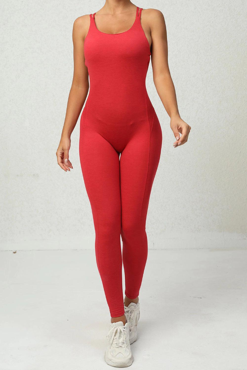 a woman wearing a red bodysuit and white tennis shoes