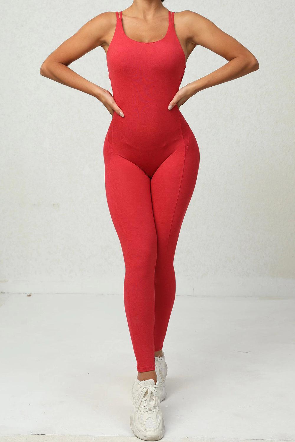 a woman in a red bodysuit posing for a picture
