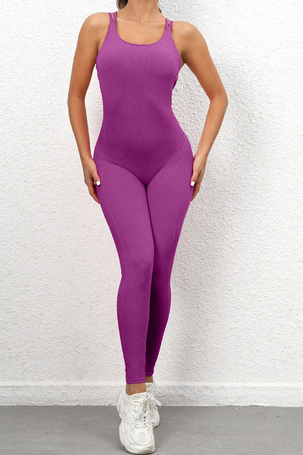 a woman in a purple bodysuit posing for a picture