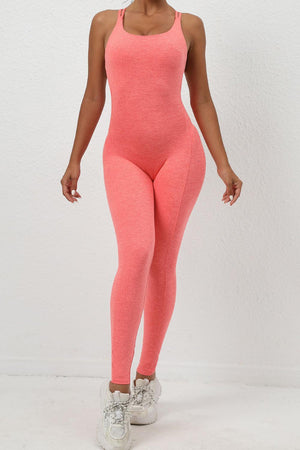 a woman wearing a pink bodysuit and sneakers