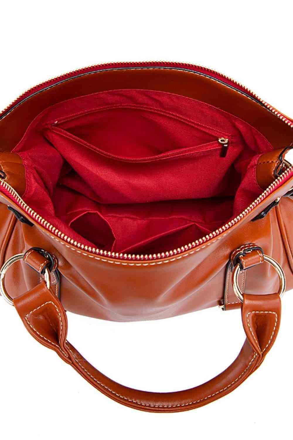 a brown handbag with a red cloth inside