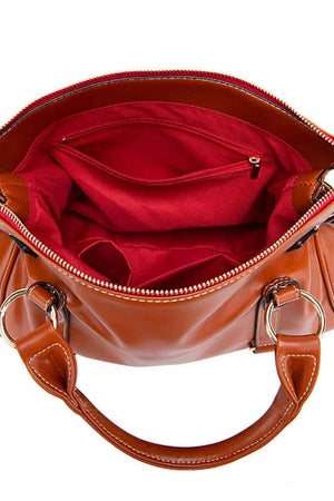a brown handbag with a red cloth inside