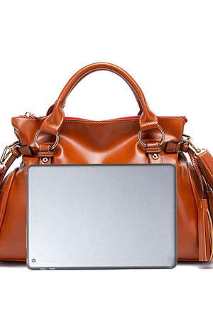 a woman's purse with a laptop on it