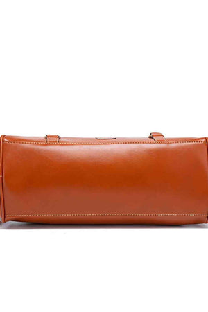 a brown leather bag with a long strap