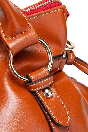 a brown handbag with a metal ring on the handle