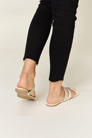 a woman in black jeans and white shoes