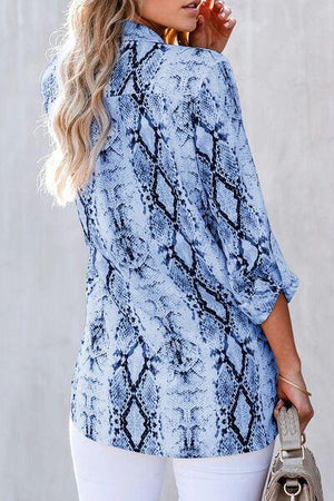 a woman in white pants and a blue shirt