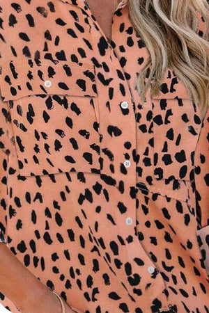 a woman wearing a leopard print shirt
