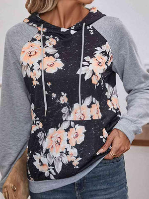 a woman wearing a hoodie with flowers on it