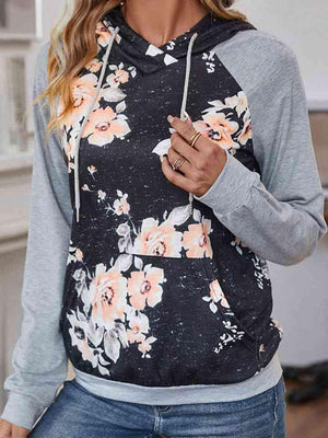 a woman wearing a hoodie with flowers on it
