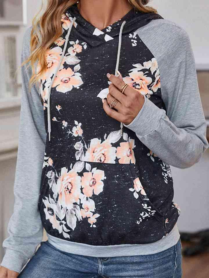 a woman wearing a hoodie with flowers on it
