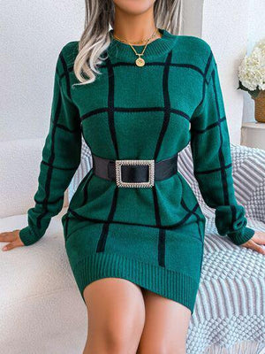 a woman in a green sweater dress posing for a picture