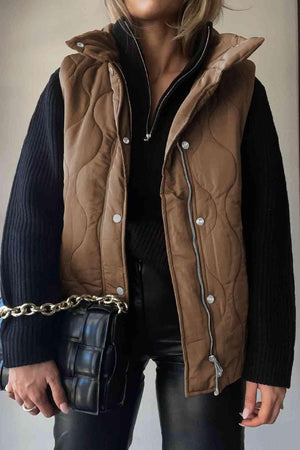 a woman wearing a brown quilted vest