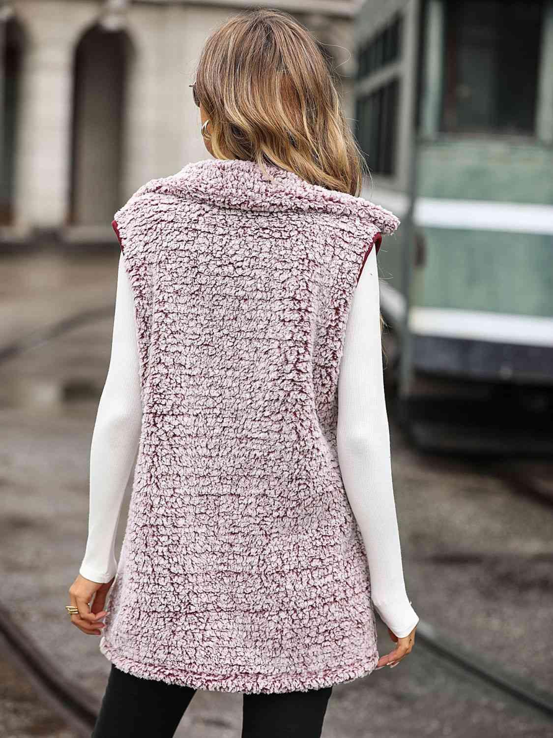 a woman wearing a pink vest and black pants