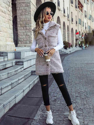 a woman wearing a hat and a fur vest