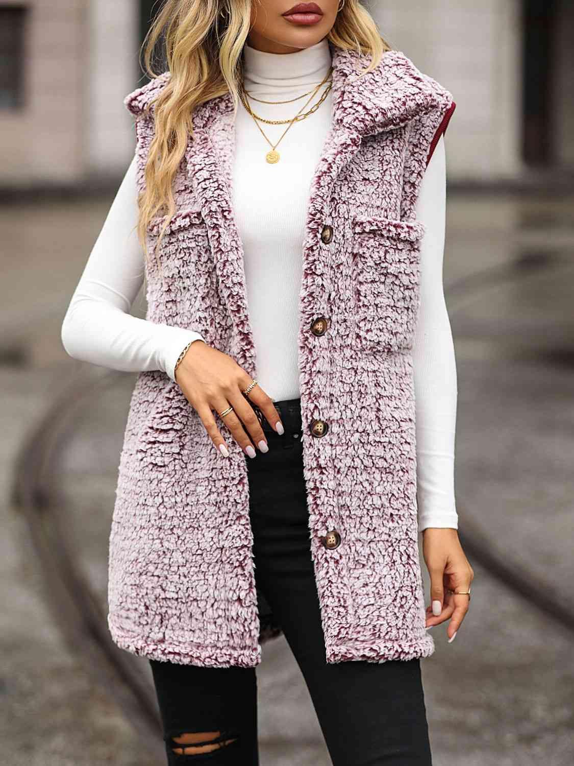 a woman wearing a pink vest and black ripped jeans