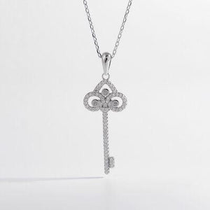 a diamond key pendant on a chain