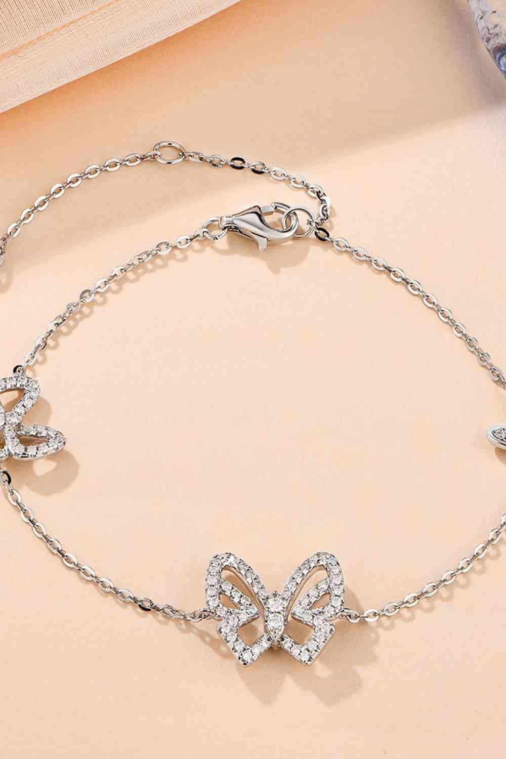 a silver bracelet with a bow on it