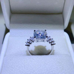 a blue diamond ring in a white box