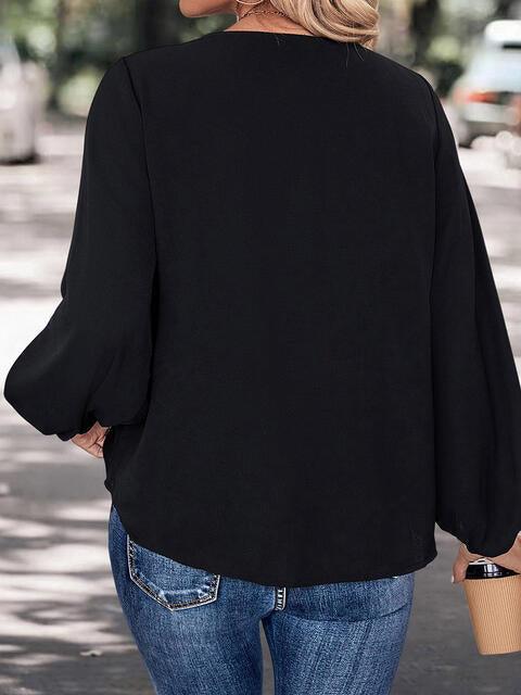 a woman walking down a street wearing a black top