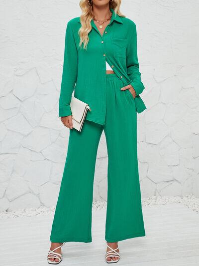 a woman wearing a green shirt and wide legged pants