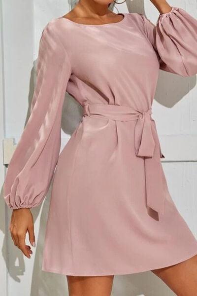 a woman in a pink dress posing for a picture