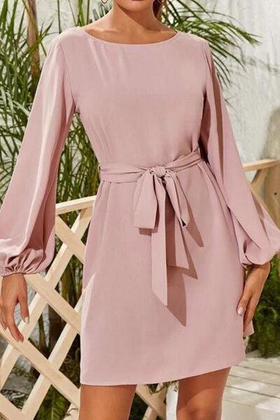 a woman in a pink dress posing for a picture