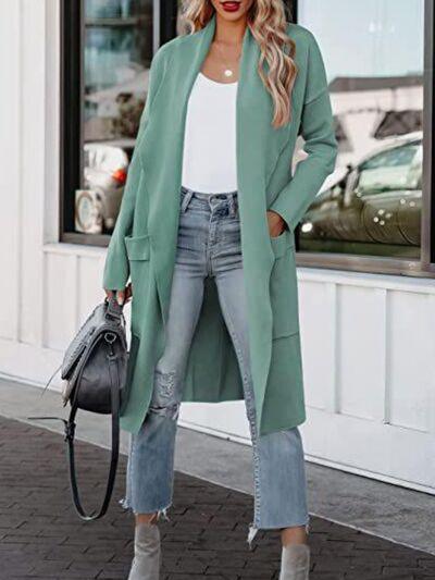 a woman wearing a green coat and jeans