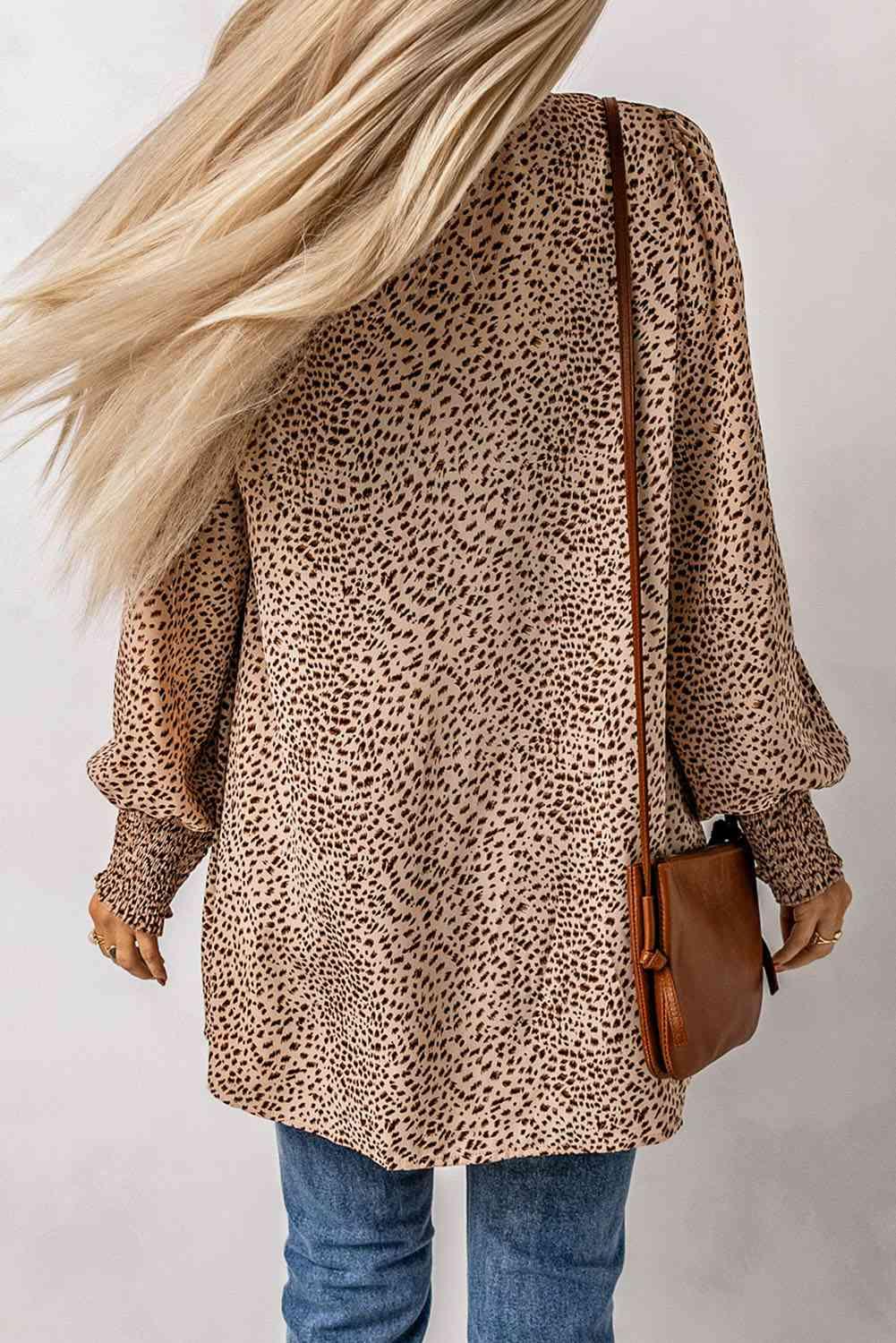 the back of a woman wearing a leopard print top