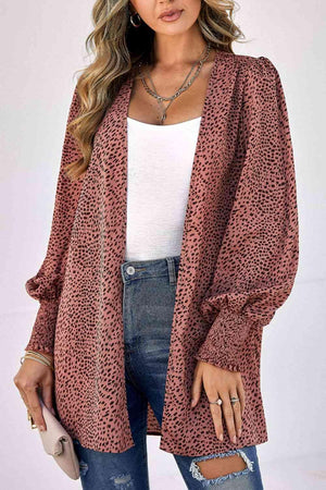 a woman wearing a leopard print cardigan sweater