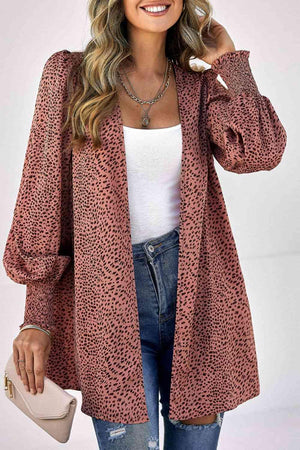 a woman wearing a leopard print cardigan